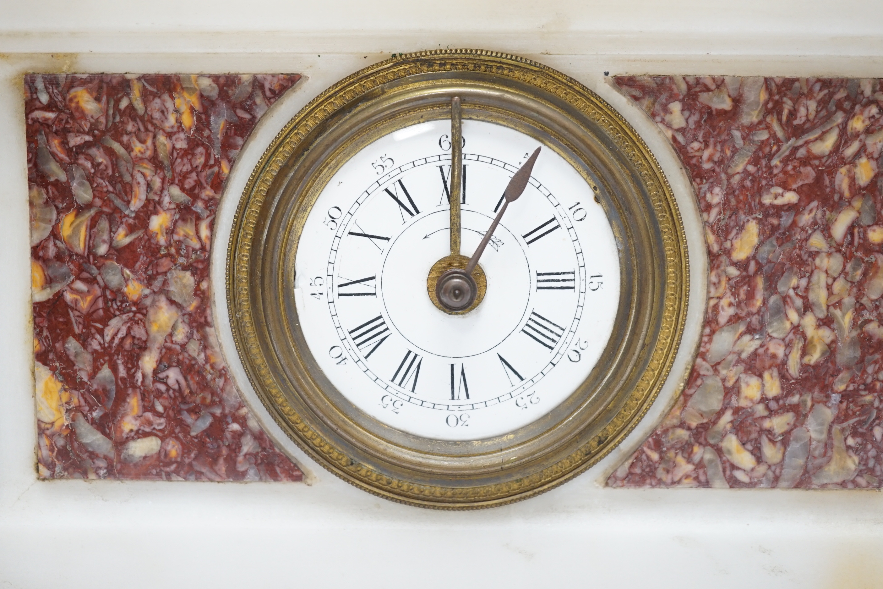 A 19th century French alabaster and rouge marble ‘hound’ mantel timepiece, 29cm tall